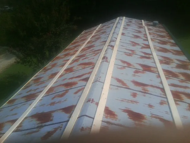 Rusted metal roof panels with new wood purlins before replacement — Storm Damage Roof Repair in Reubens by Roofing Brothers